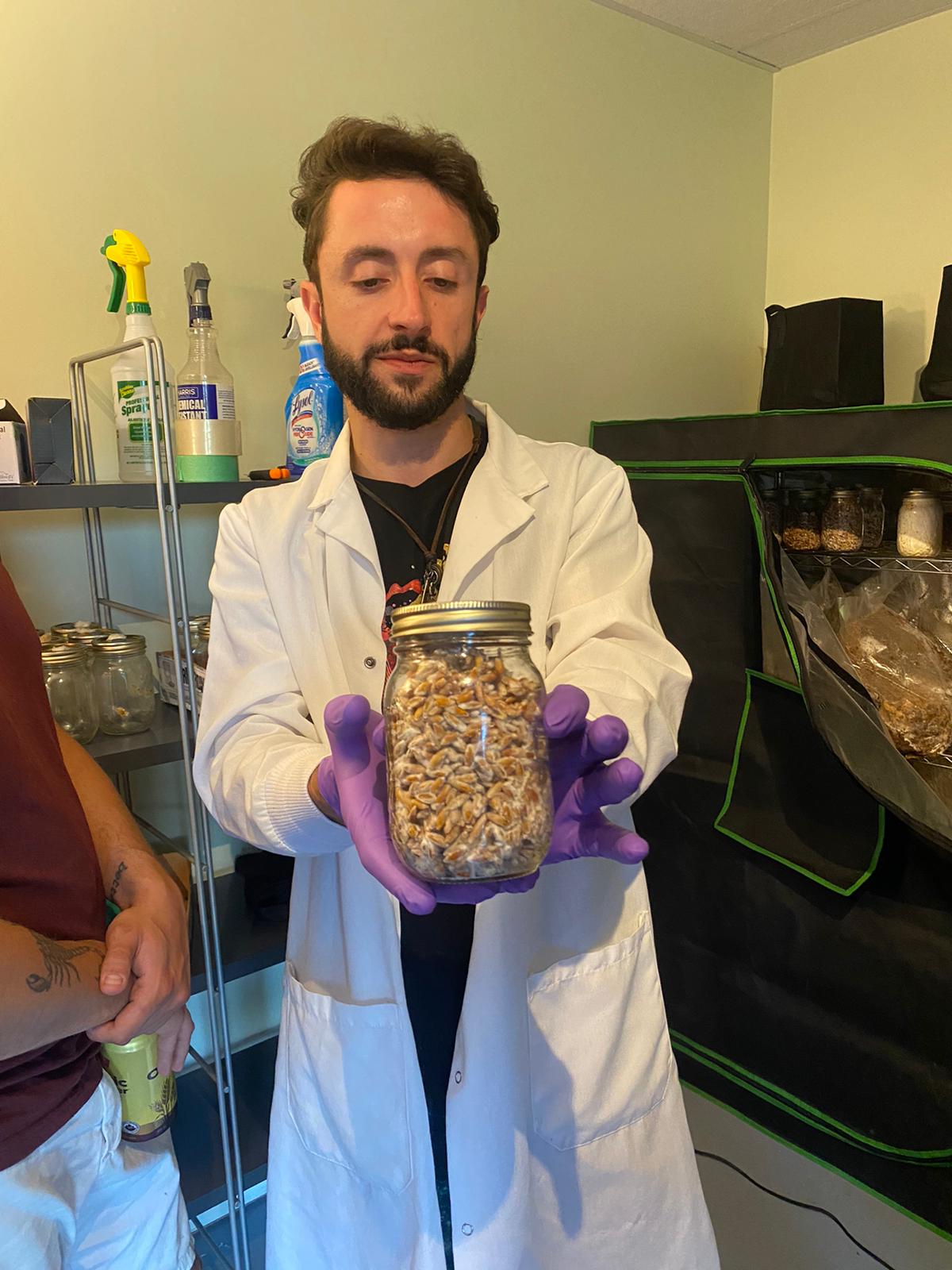 Lab coat and grain spawn jar — mushroom cultivation