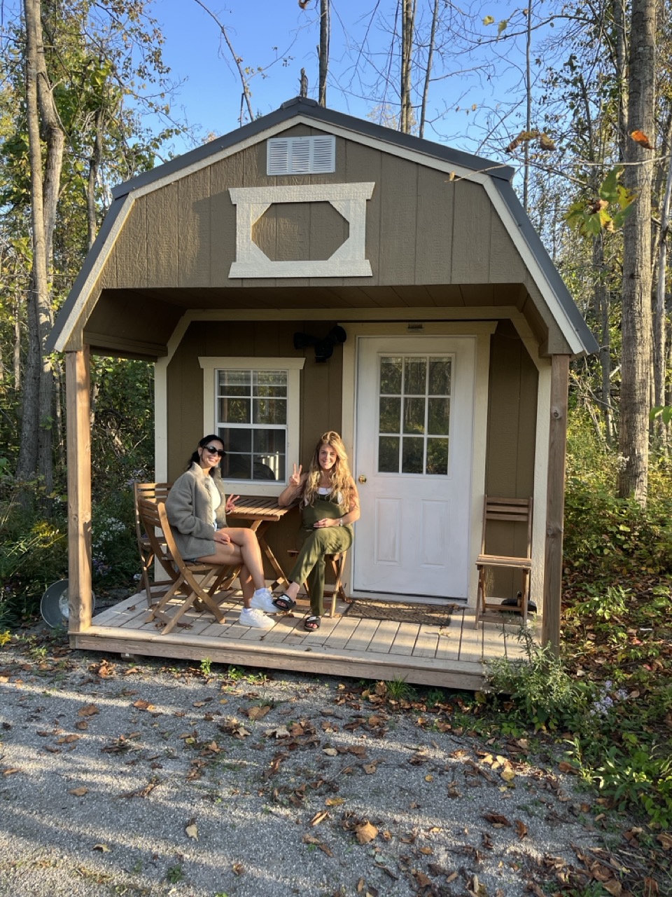 Tiny House Community - friends on the cabin porch in fall